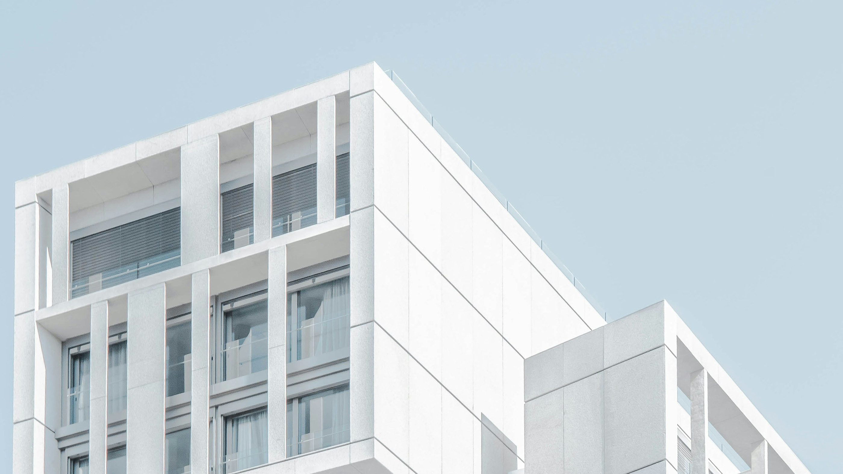 A modern apartment building against a clear sky